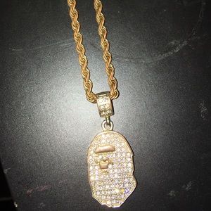 A gold and diamond bape chain .