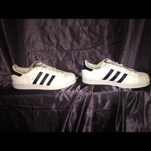 White and black Adidas Superstars