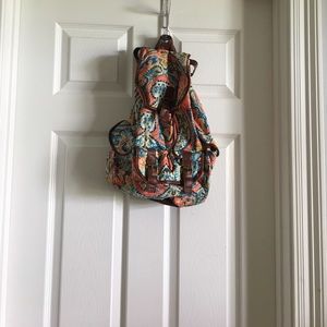 colorful backpack with brown leather straps