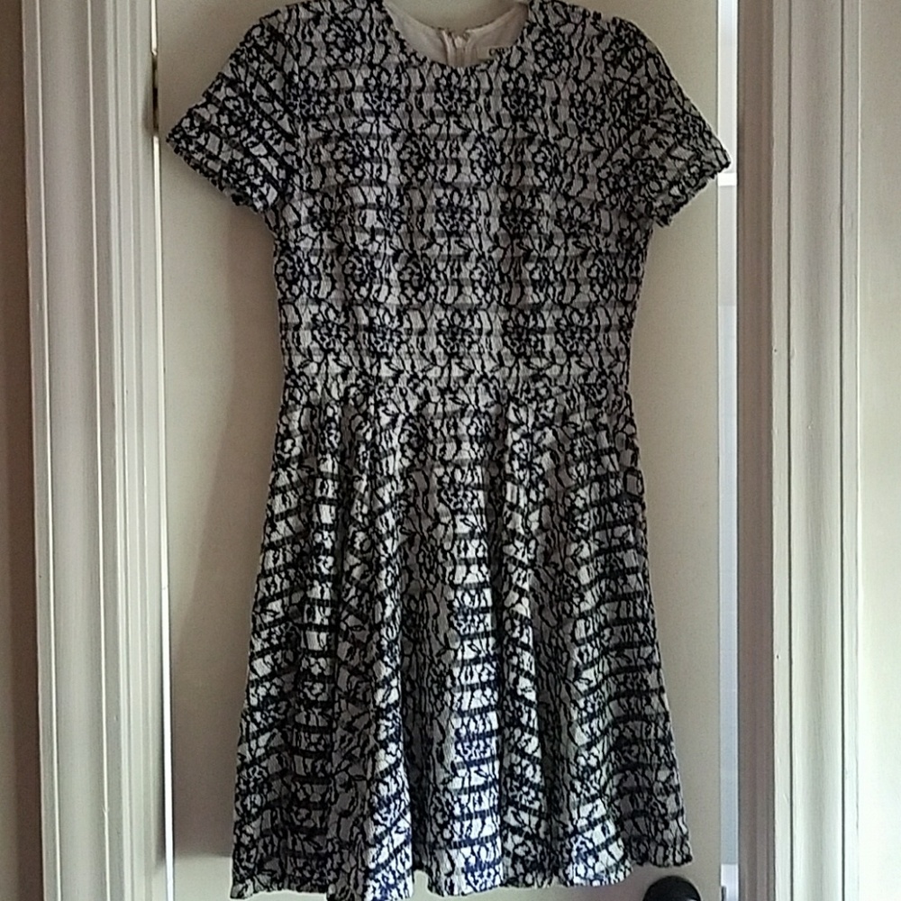 Cream dress with navy lace overlay.