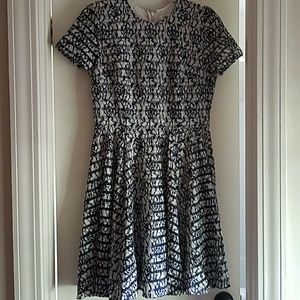 Cream dress with navy lace overlay.