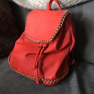 Red leather backpack with gold detail