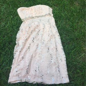 A fancy light pink dress that has gems.