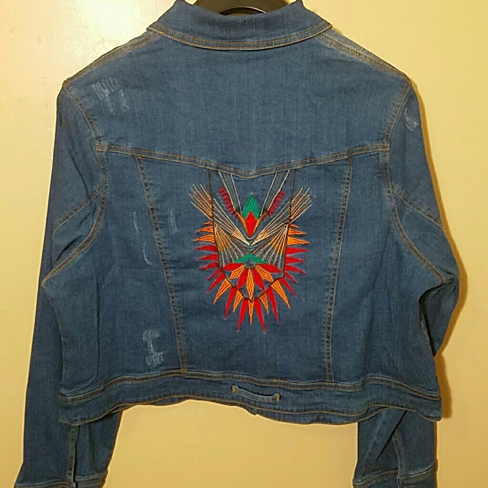Ripped denim jacket with embroidery at the back