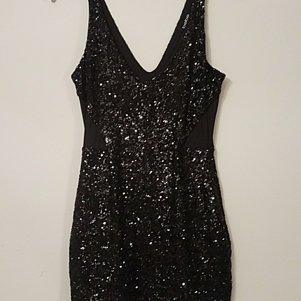 Black sequin bebe dress with illusion details.