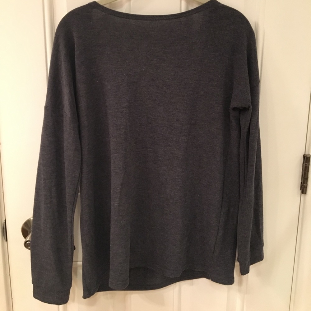 Never worn casual sweater with an open back