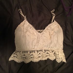 white crochet-like top with flower patterns