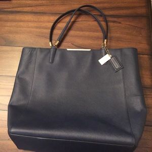 Navy blue coach bag with gold details