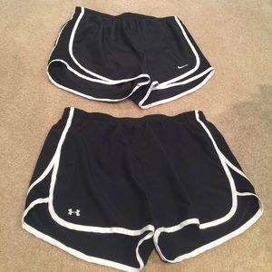 Two black athletic shorts. Nike and Under Armour