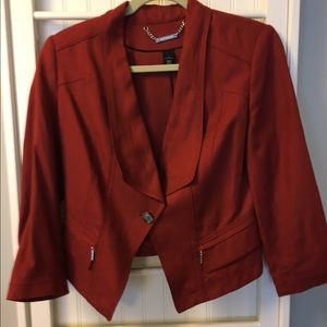 Rust colored jacket w/silver zippers on pockets