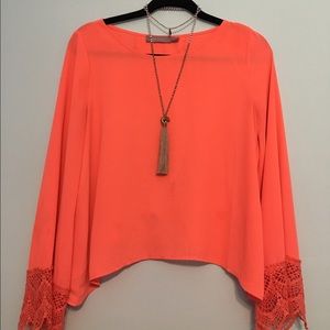 bright coral blouse with open back