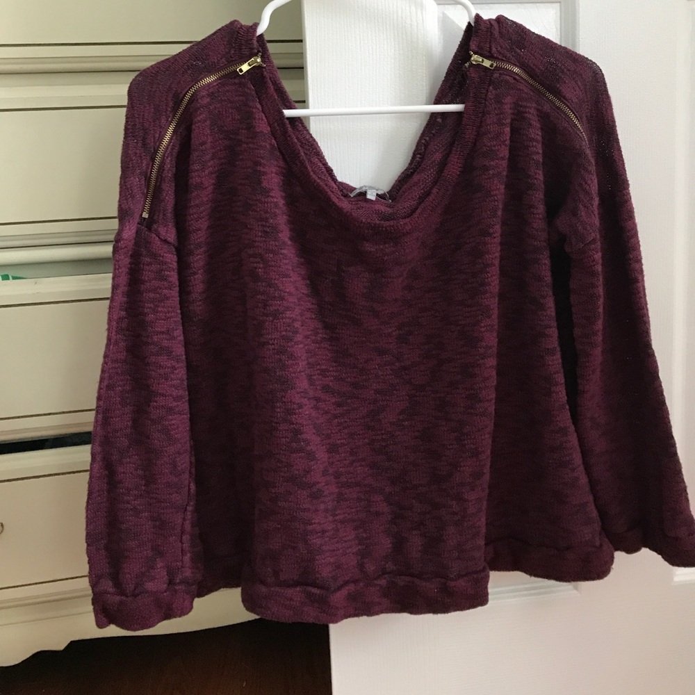 Maroon sweater with gold zipper detailing