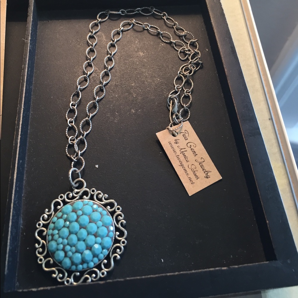 Antique silver necklace with turquoise pendant.