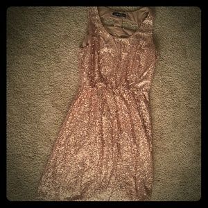 Champagne sequin mini dress with back cutouts.