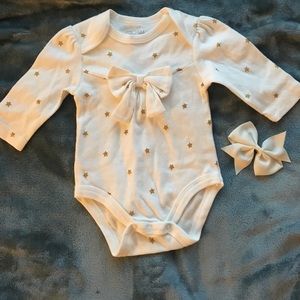 Cream onesie with cute gold stars.