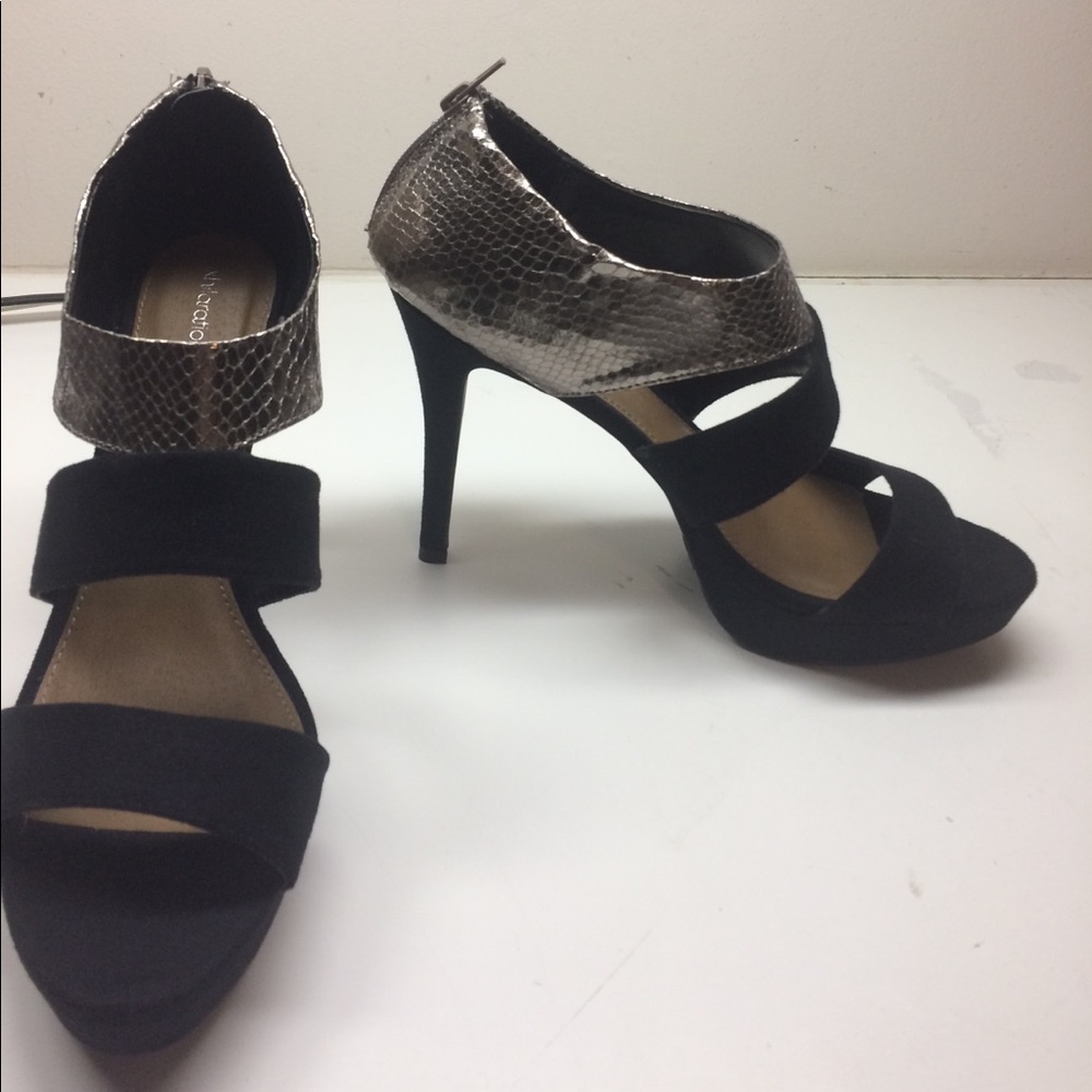 Black heels with a goldish silver top.