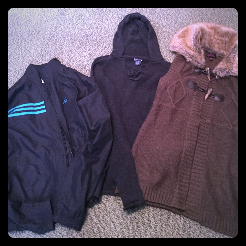 Assorted sweaters and rain coat