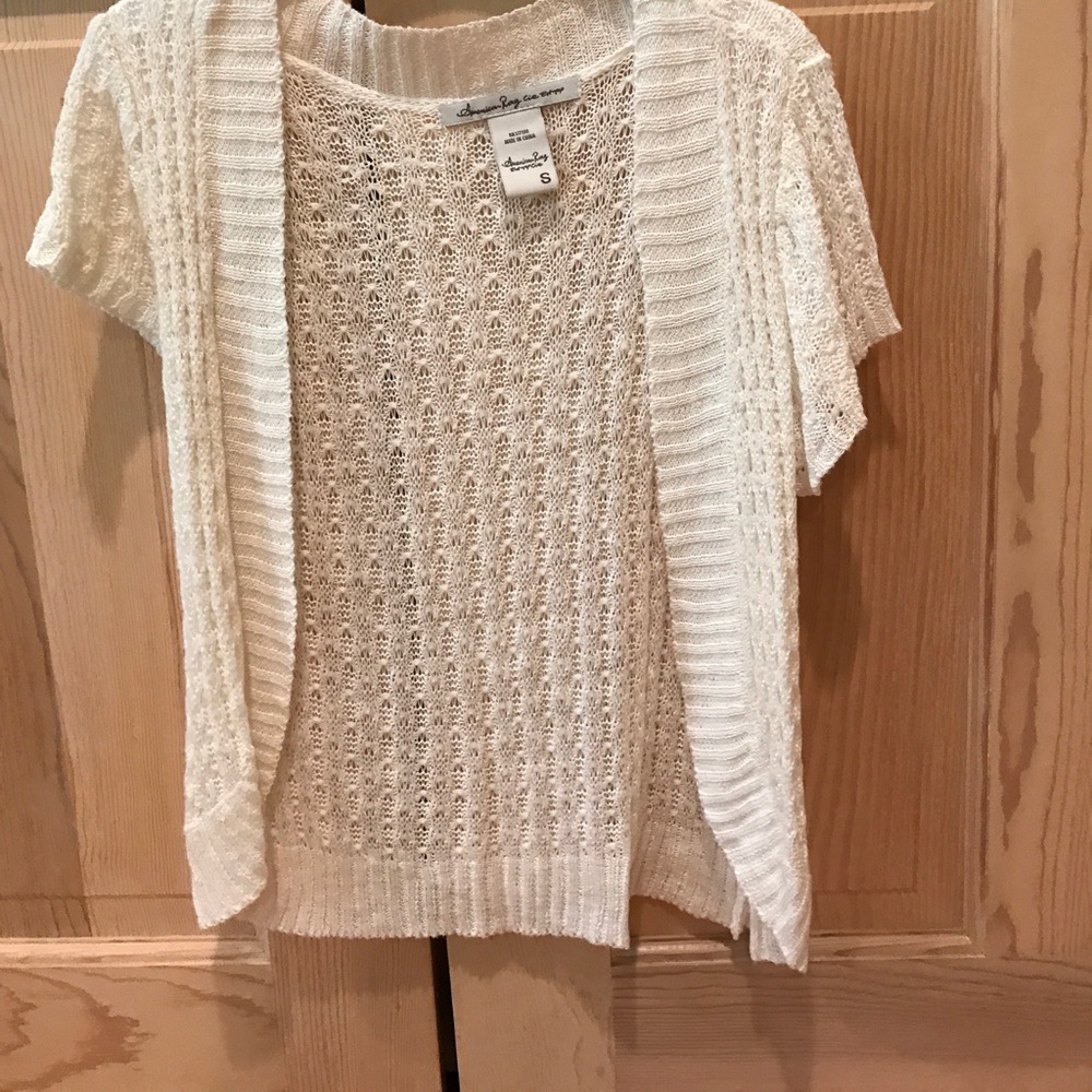 Cream colored short sleeve shawl.