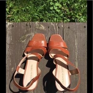 Dark tan leather sandals.