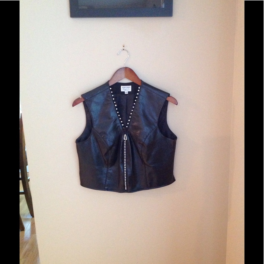 Black vest with foe diamonds imbedded into zipper.