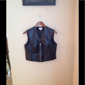Black vest with foe diamonds imbedded into zipper.