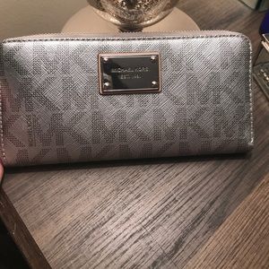 A large Michael Kors used wallet.