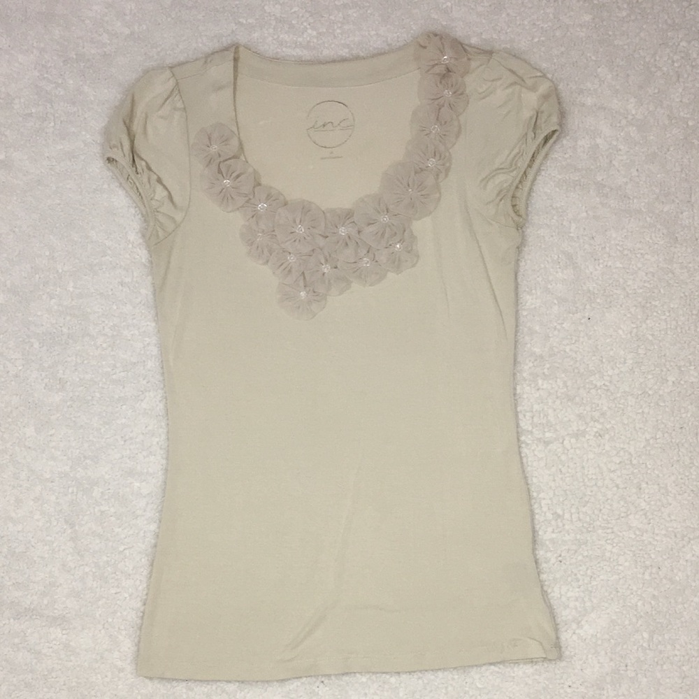 Scoop neck line with decorative flowers.