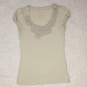 Scoop neck line with decorative flowers.