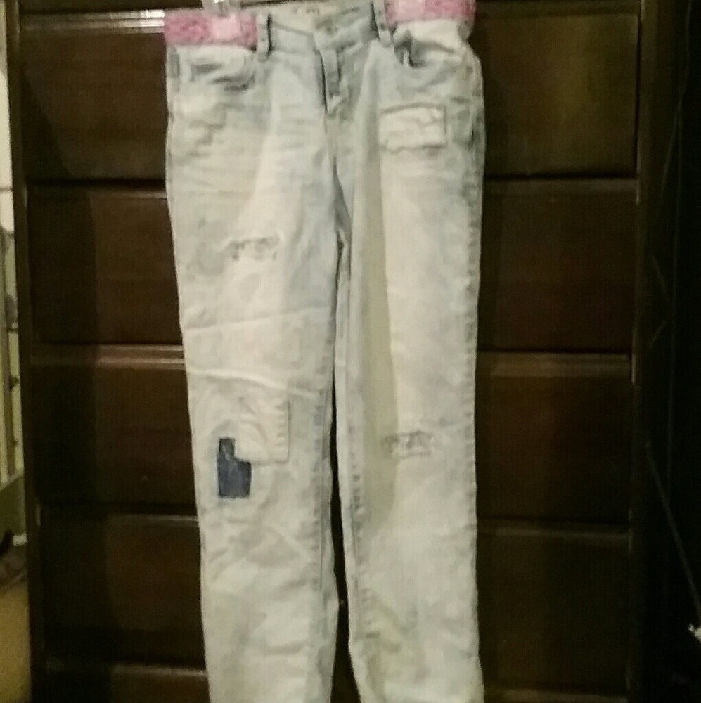 Patched and ripped acid wash jeans