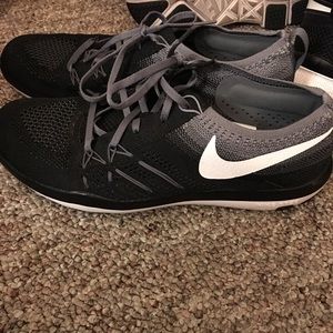Black, white, and gray Nike tennis shoes.
