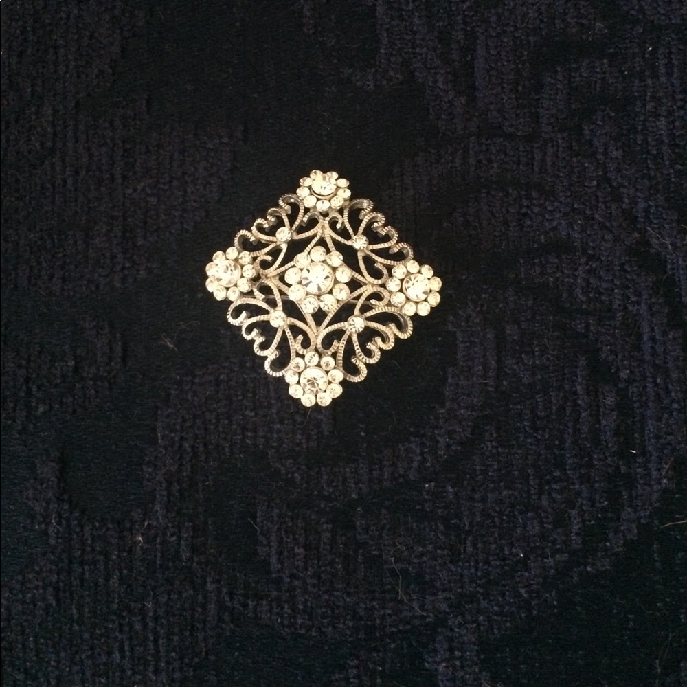 Rhinestone & silver square brooch.
