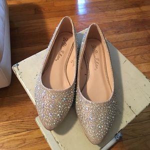 Shiny gold ballerina shoes with sparkly jewels.