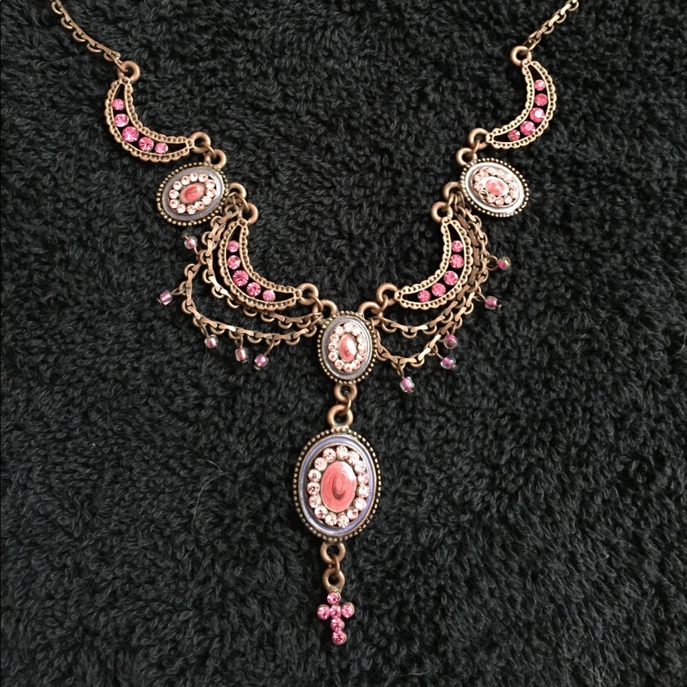 Pink statement necklace with very delicate cross.
