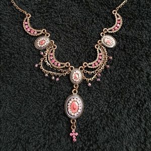 Pink statement necklace with very delicate cross.