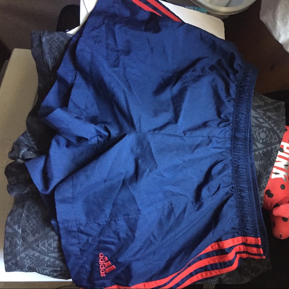 Adidas navy blue and red drawstring shorts.