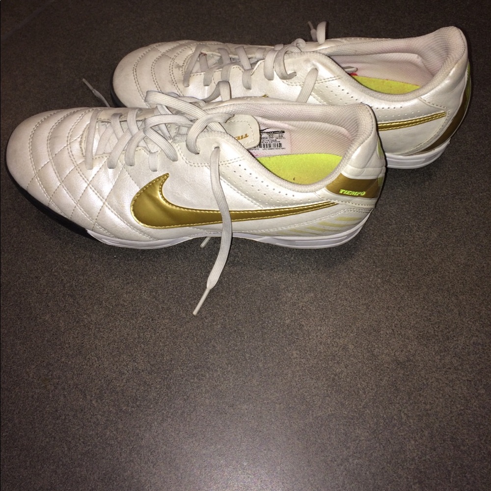 White and gold Nike indoor cleats
