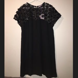 black dress with a mesh top and 3D flowers