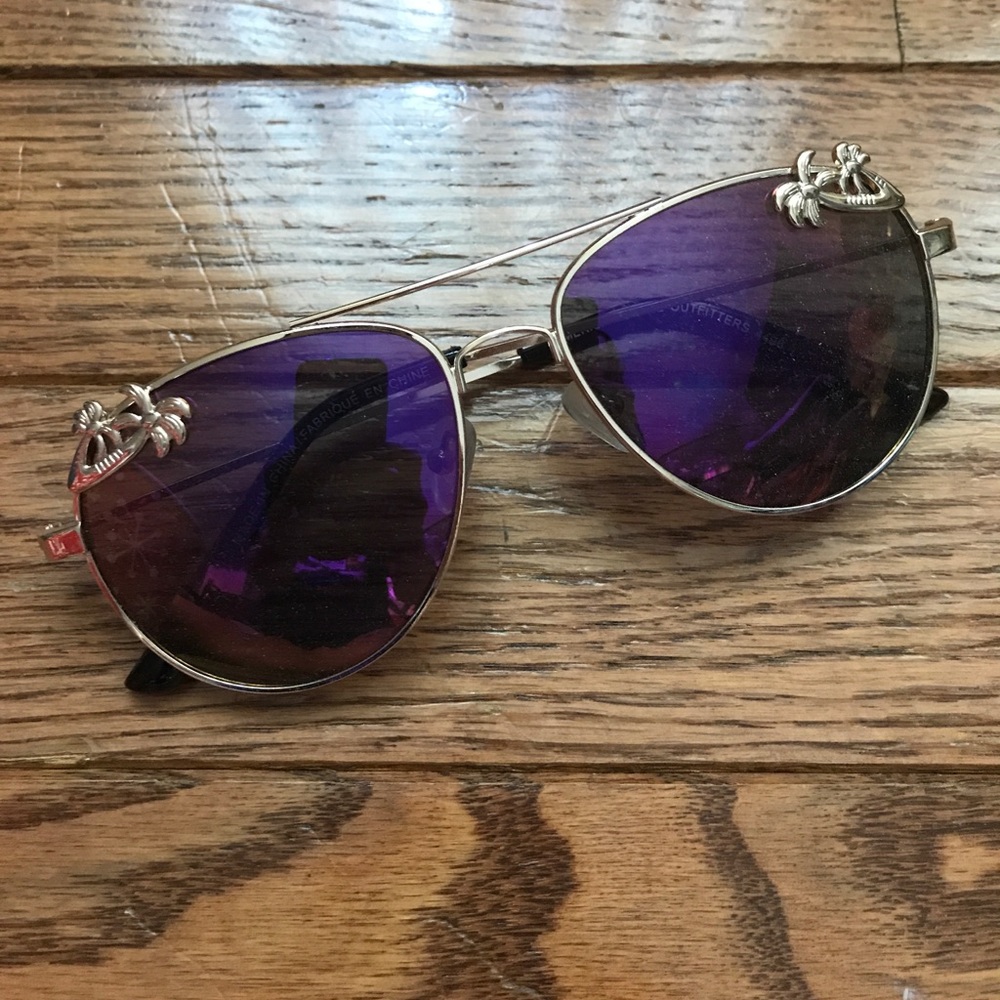 gold aviators with palm trees in the corners