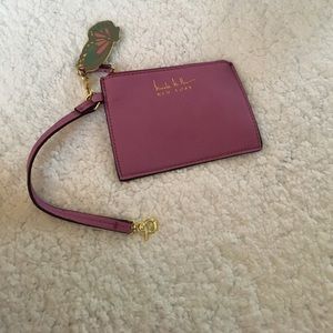 Nicole Miller coin purse with butterfly charm.