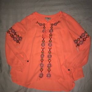 Bright orange shirt.