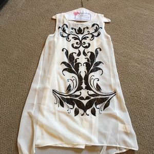 White slip dress with sheer embellished cover