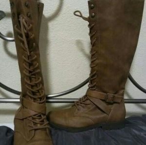 Long lace up boots with zipper on the side.