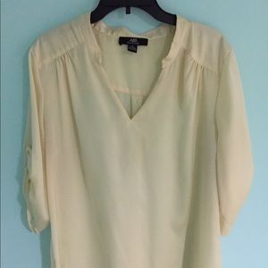 Sheer cream blouse with rolled up sleeve detail