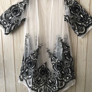 White chiffon jacket w gorgeous paisley trim .