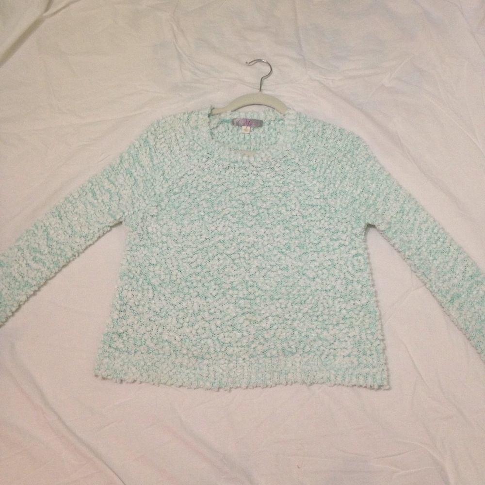 turquoise sweater with white fluff all over
