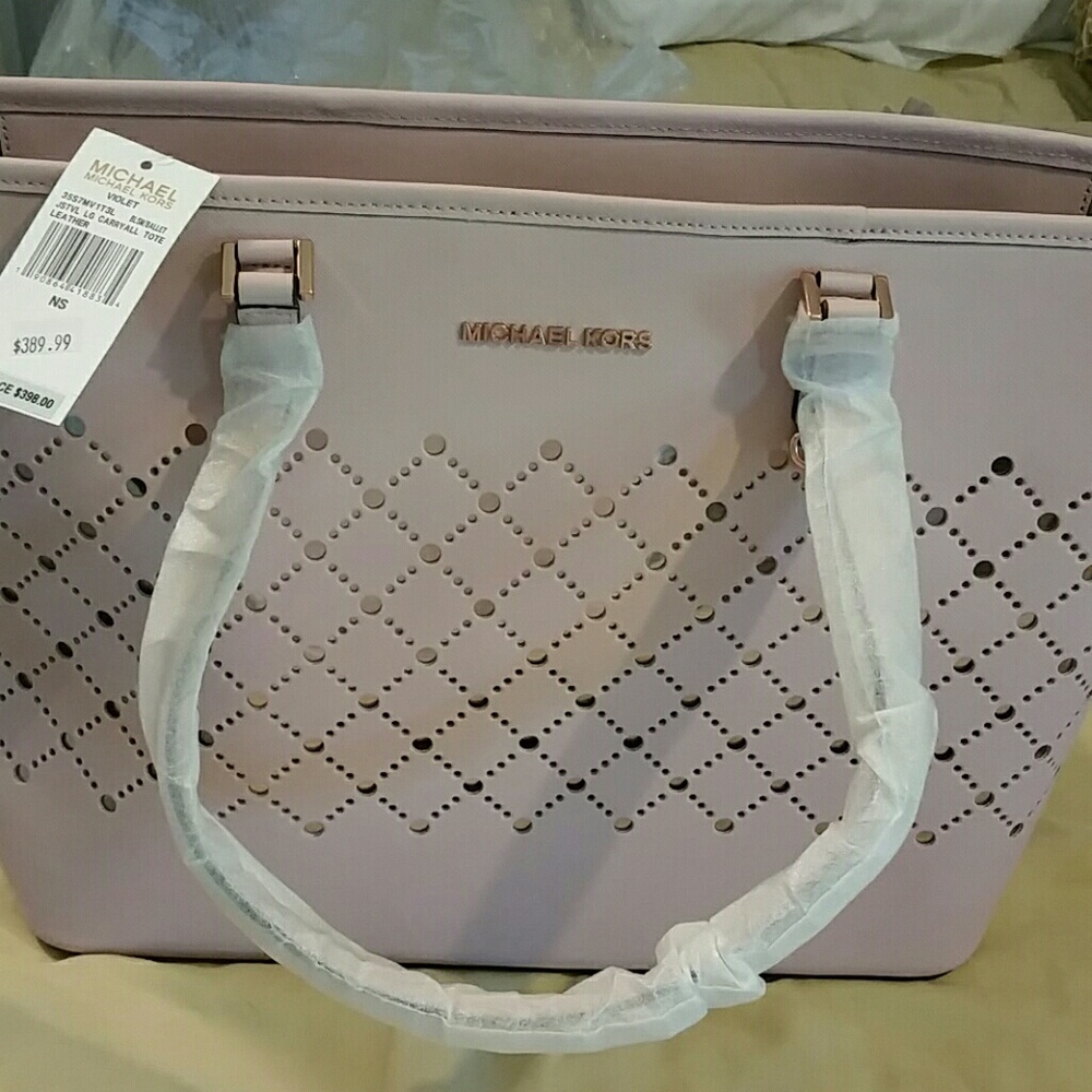 Large Michael kors jet set "violet" color is pink.