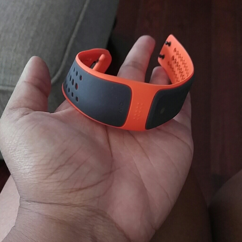 Orange theory wrist heart monitor with charger.