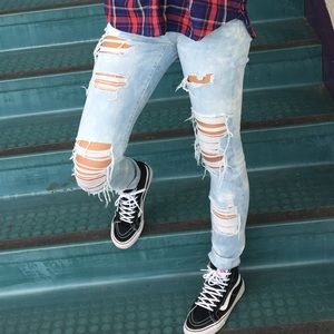 Distressed light acid wash denim jeans