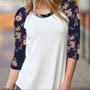 White baseball Tee with Navy Floral print sleeves.