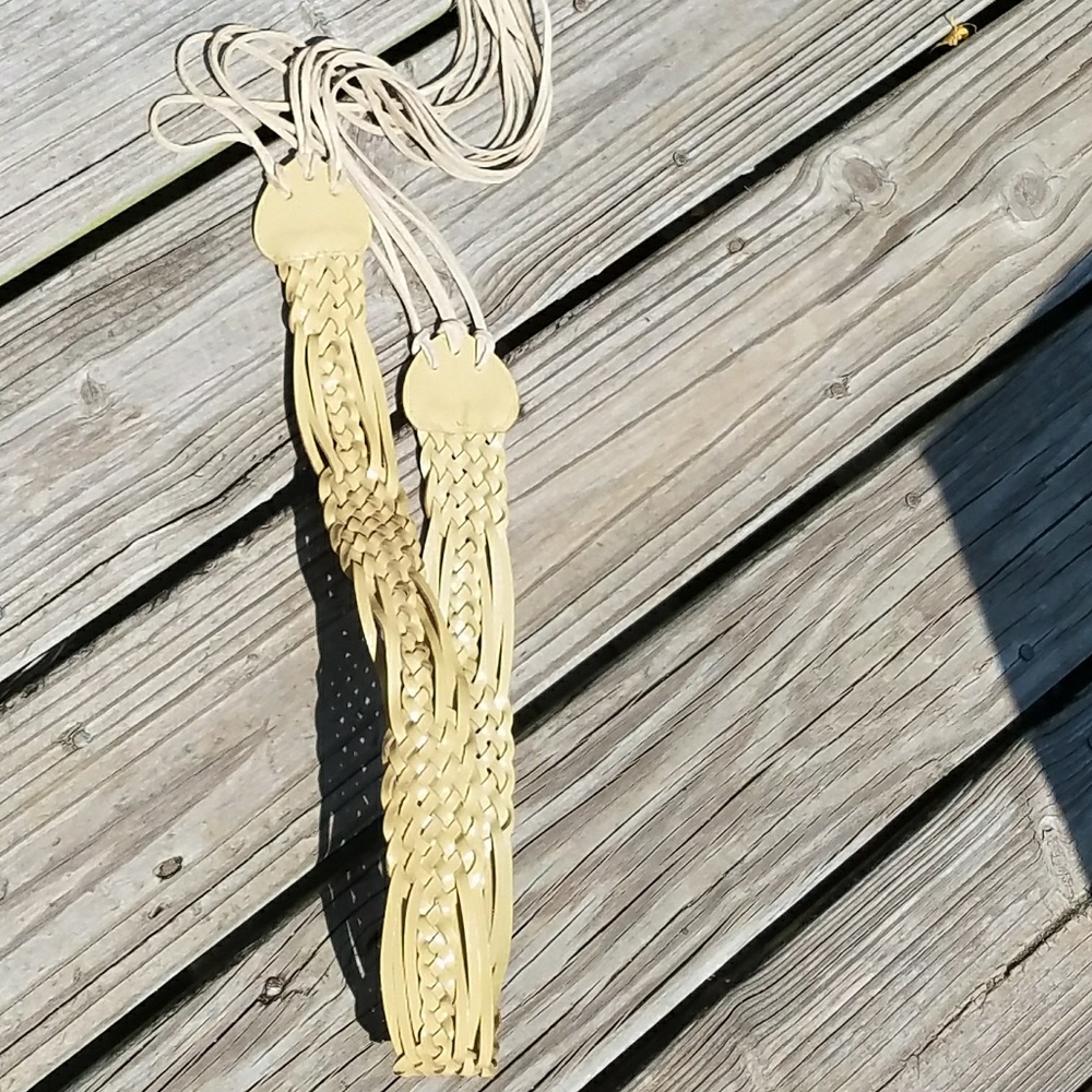 Cream colored leather like belt with tassels